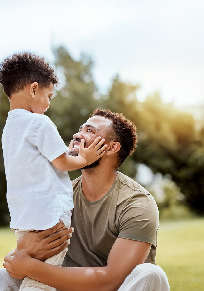What-to-expect-from-counseling a male holding what appears to be his child. The child has his hands on his dads face.